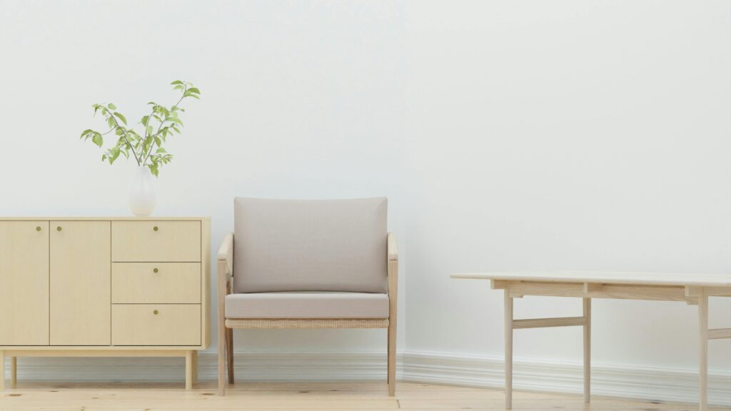 A serene minimalist living room with wooden furniture and a plant.